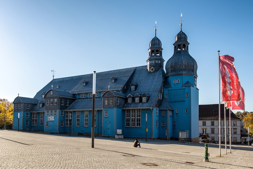 a large blue building with a clock tower