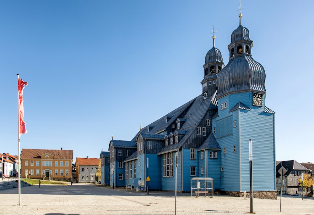 a large blue building with a clock tower