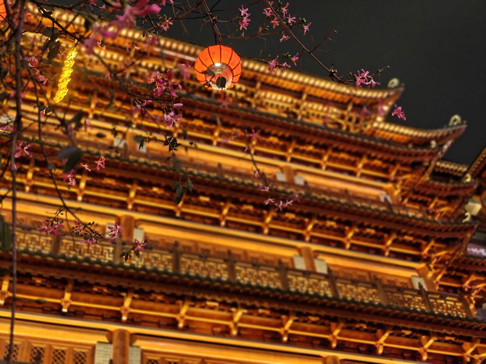 a tall building with a red lantern hanging from it's side