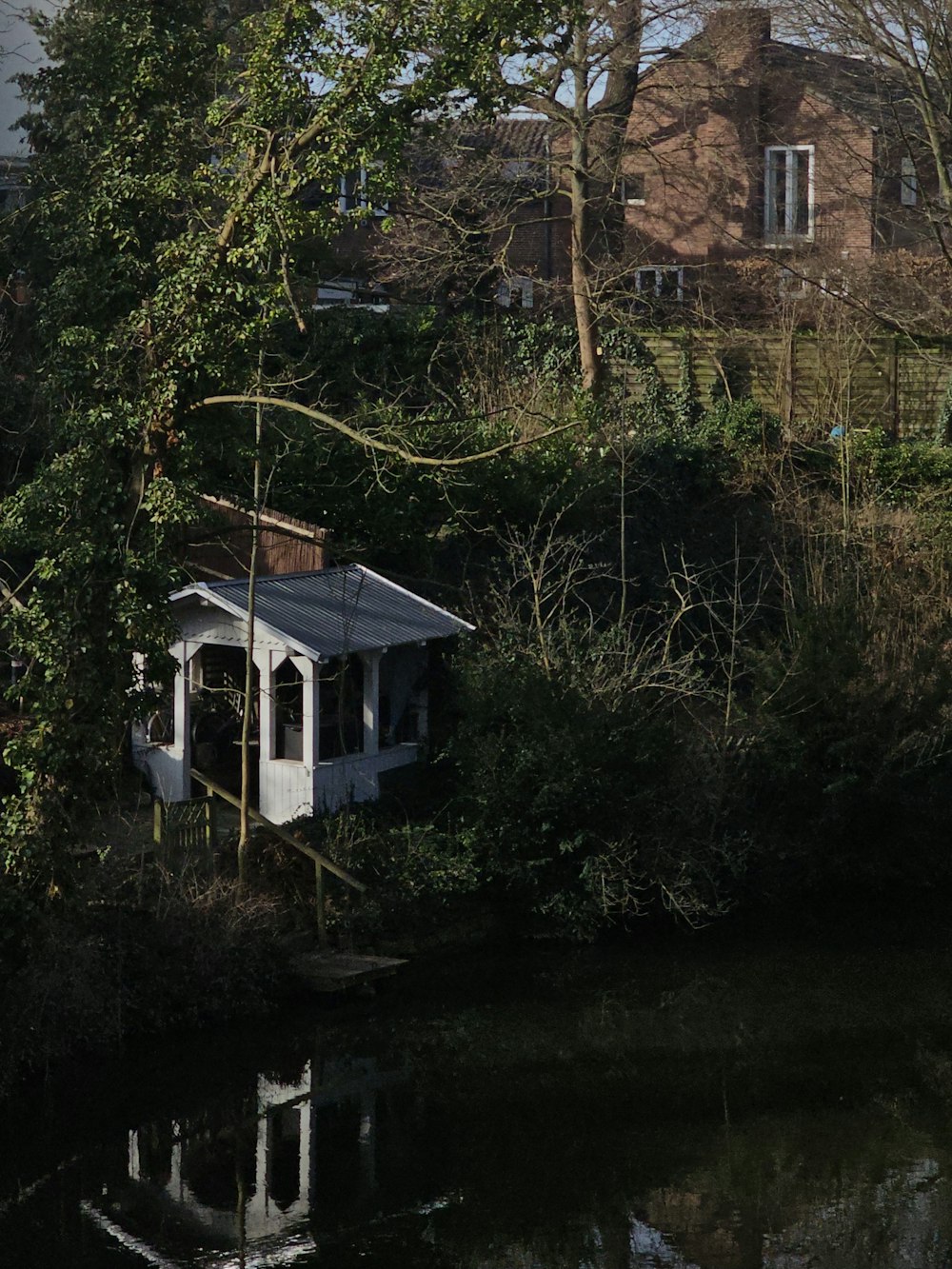 a white house sitting on top of a lush green hillside