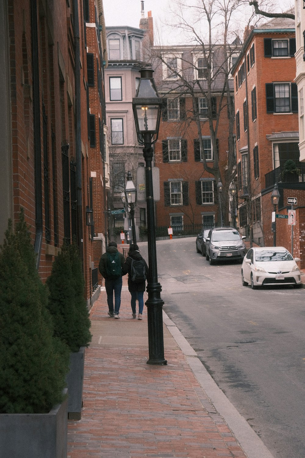 a couple of people walking down a street