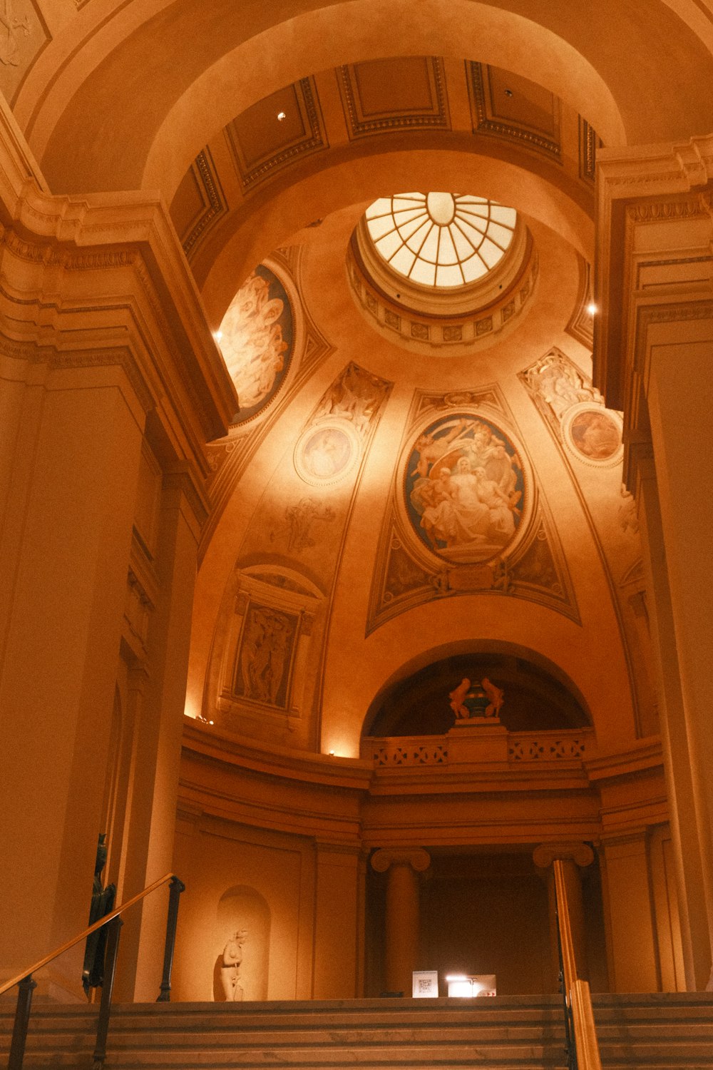 a staircase leading up to a domed ceiling in a building