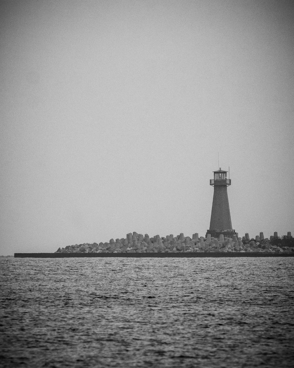 a black and white photo of a light house