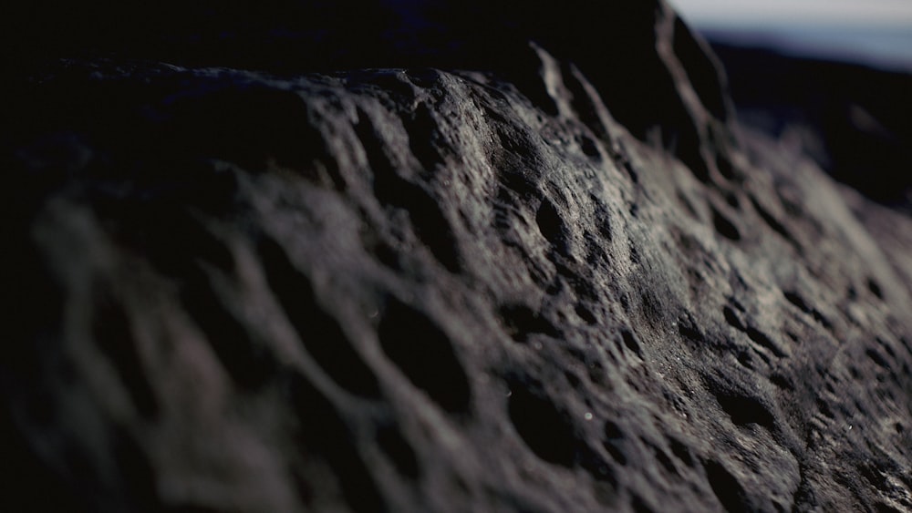 a close up of a rock with a sky in the background