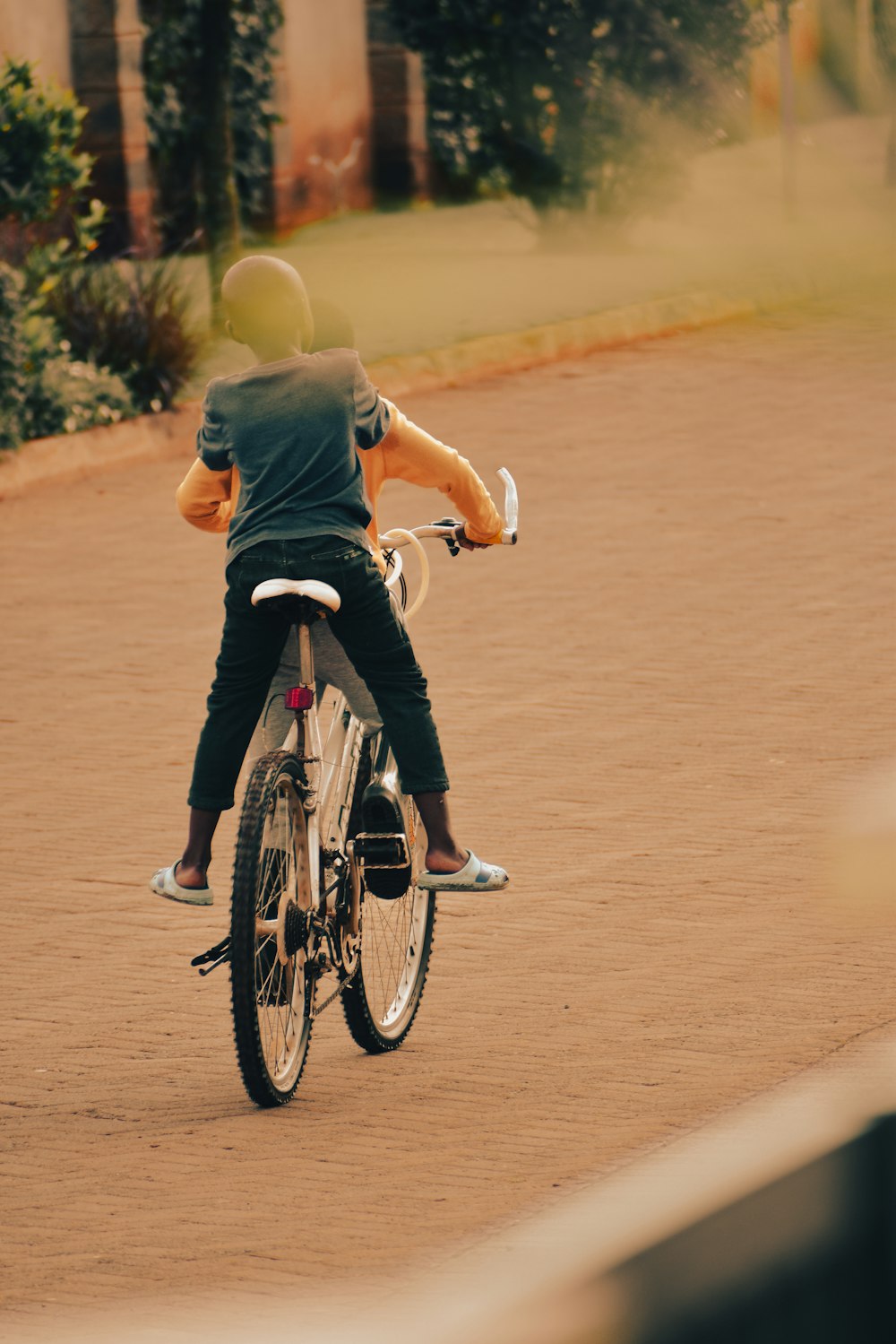 a person riding a bike on a dirt road