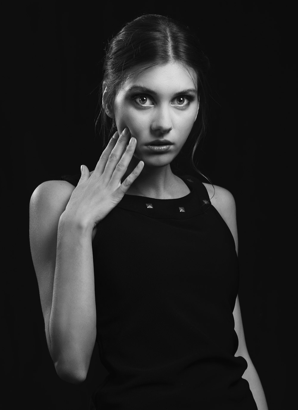 a woman in a black dress posing for a picture