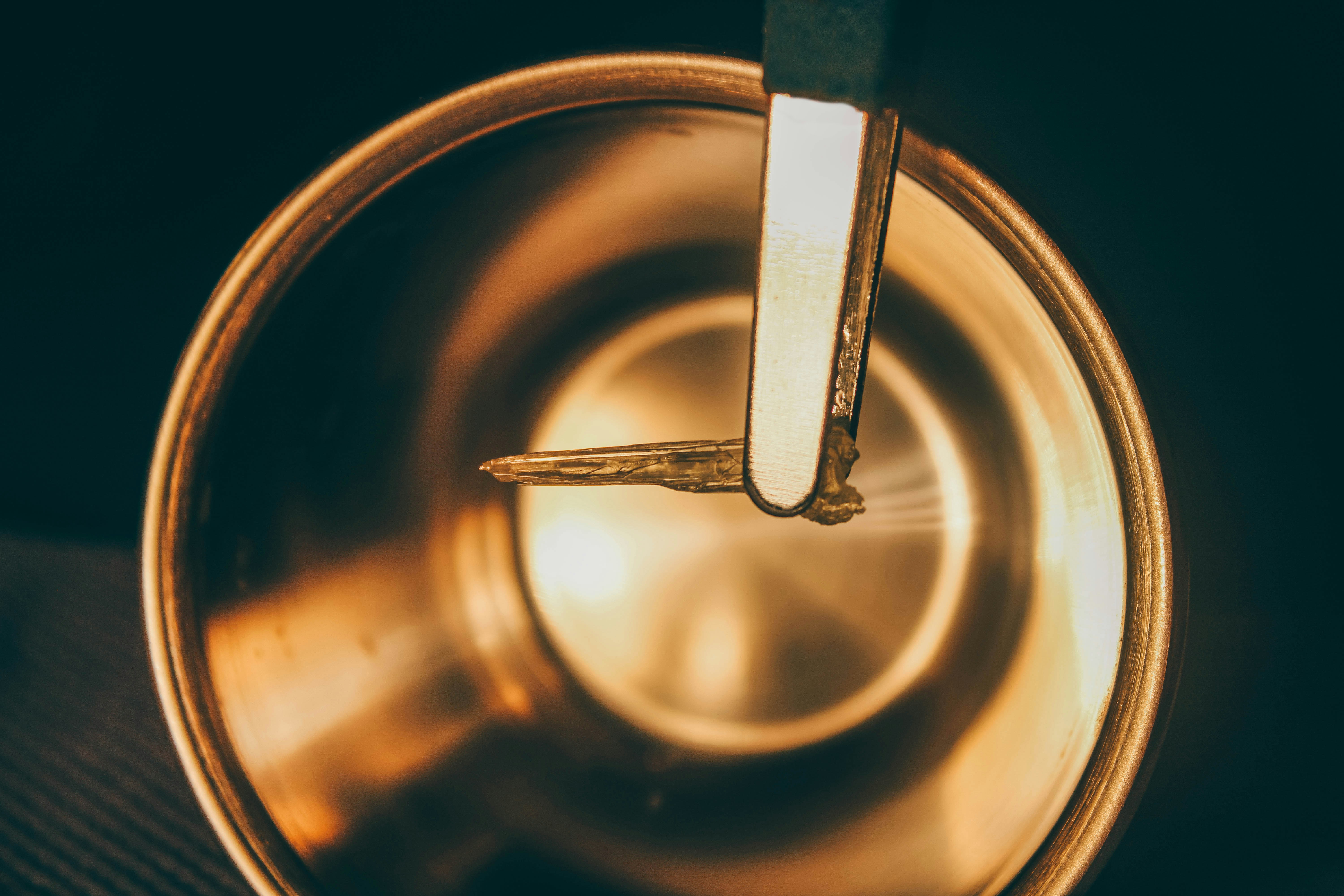 a metal cup with a spoon inside of it