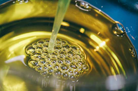 a metal bowl filled with yellow liquid