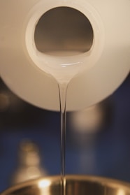 a close up of a liquid being poured into a bowl
