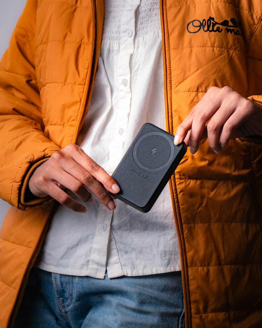 a person holding a cell phone in their hand