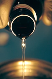 a close up of a wine glass being filled with wine
