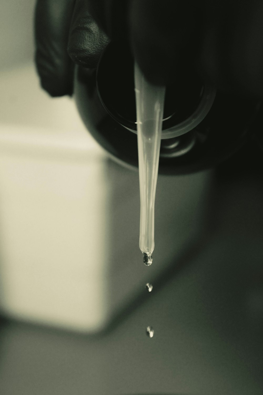 a black and white photo of a faucet with water coming out of it