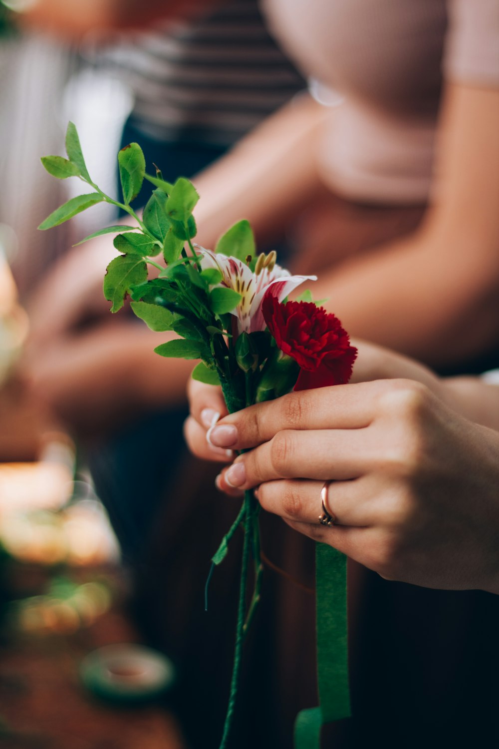 a woman is holding a bouquet of flowers