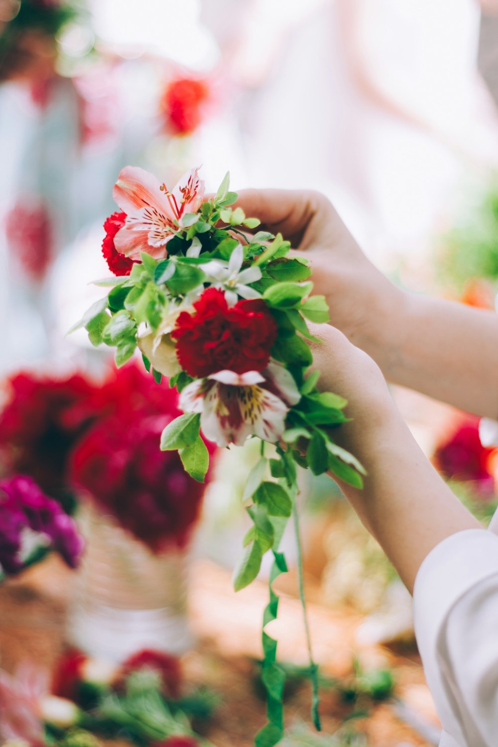 a person holding a bunch of flowers in their hands