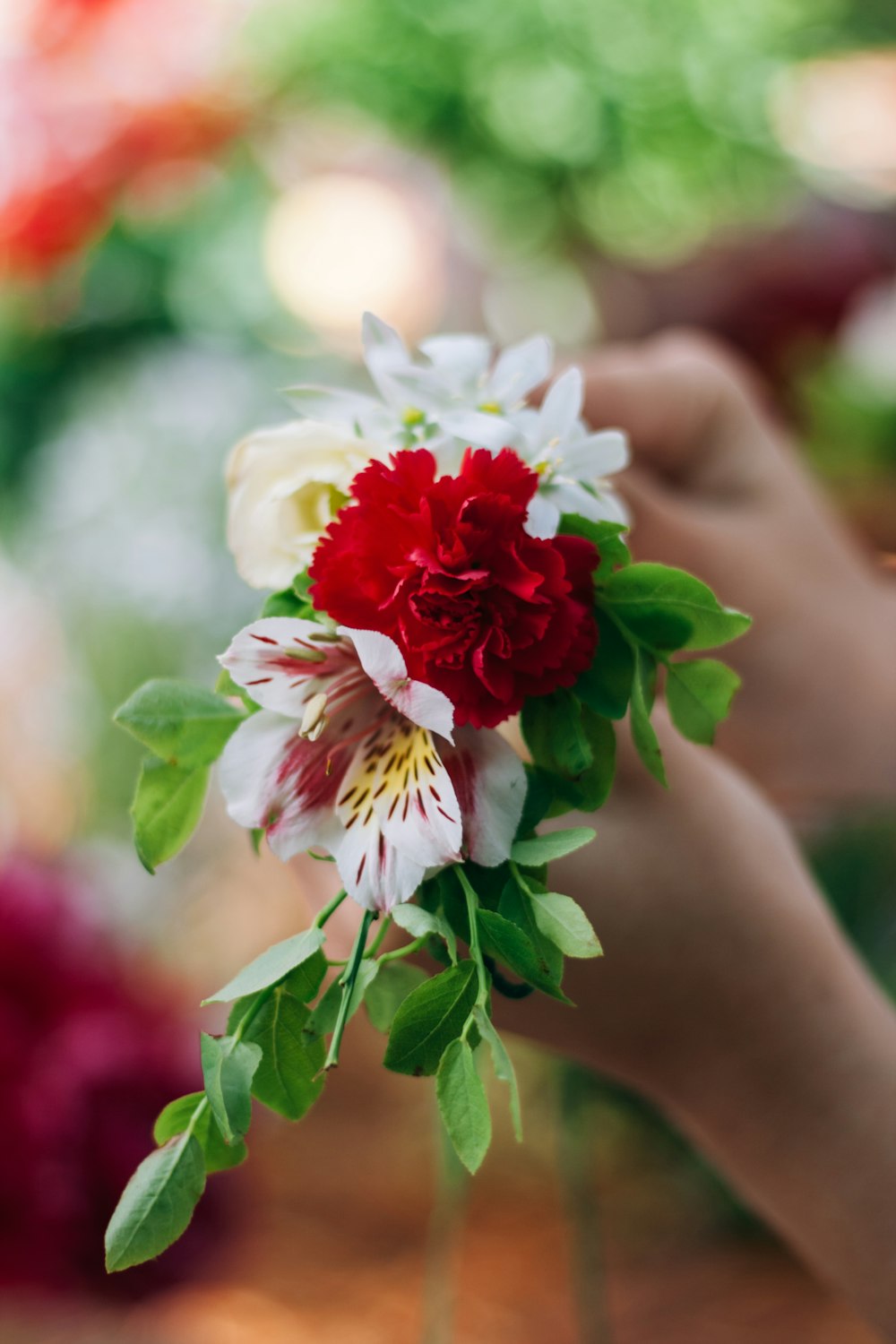 a person holding a bouquet of flowers in their hand