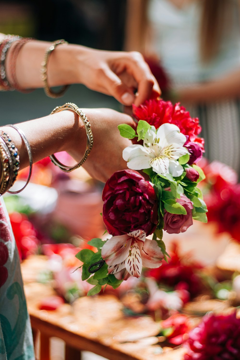 a close up of a person holding a bouquet of flowers