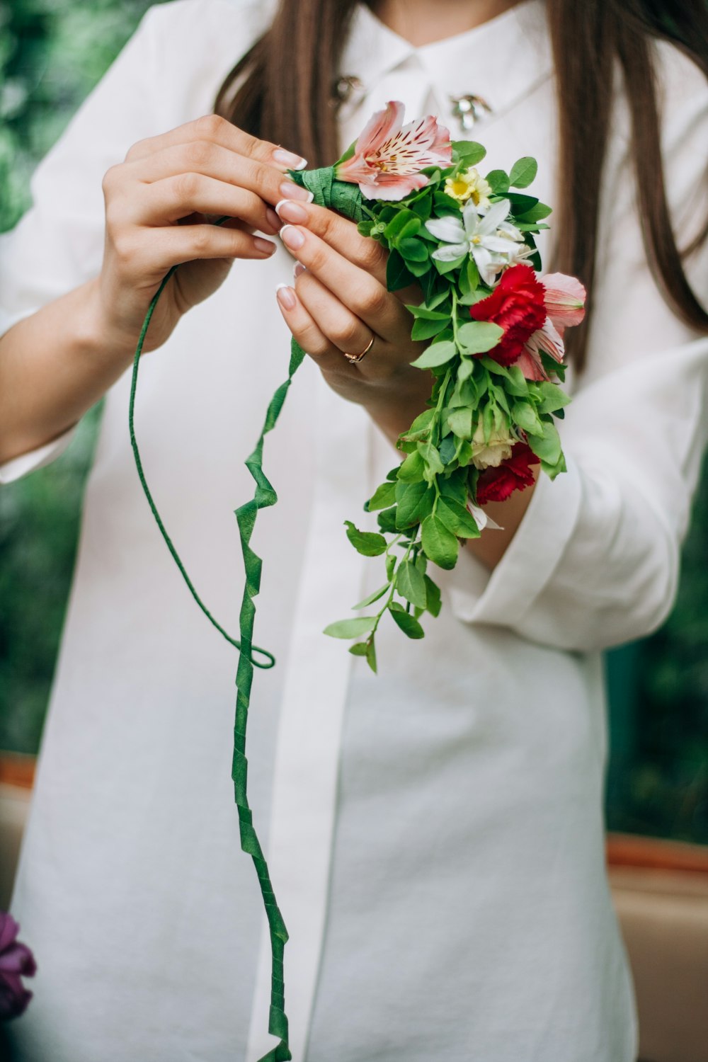 a woman is holding a bunch of flowers