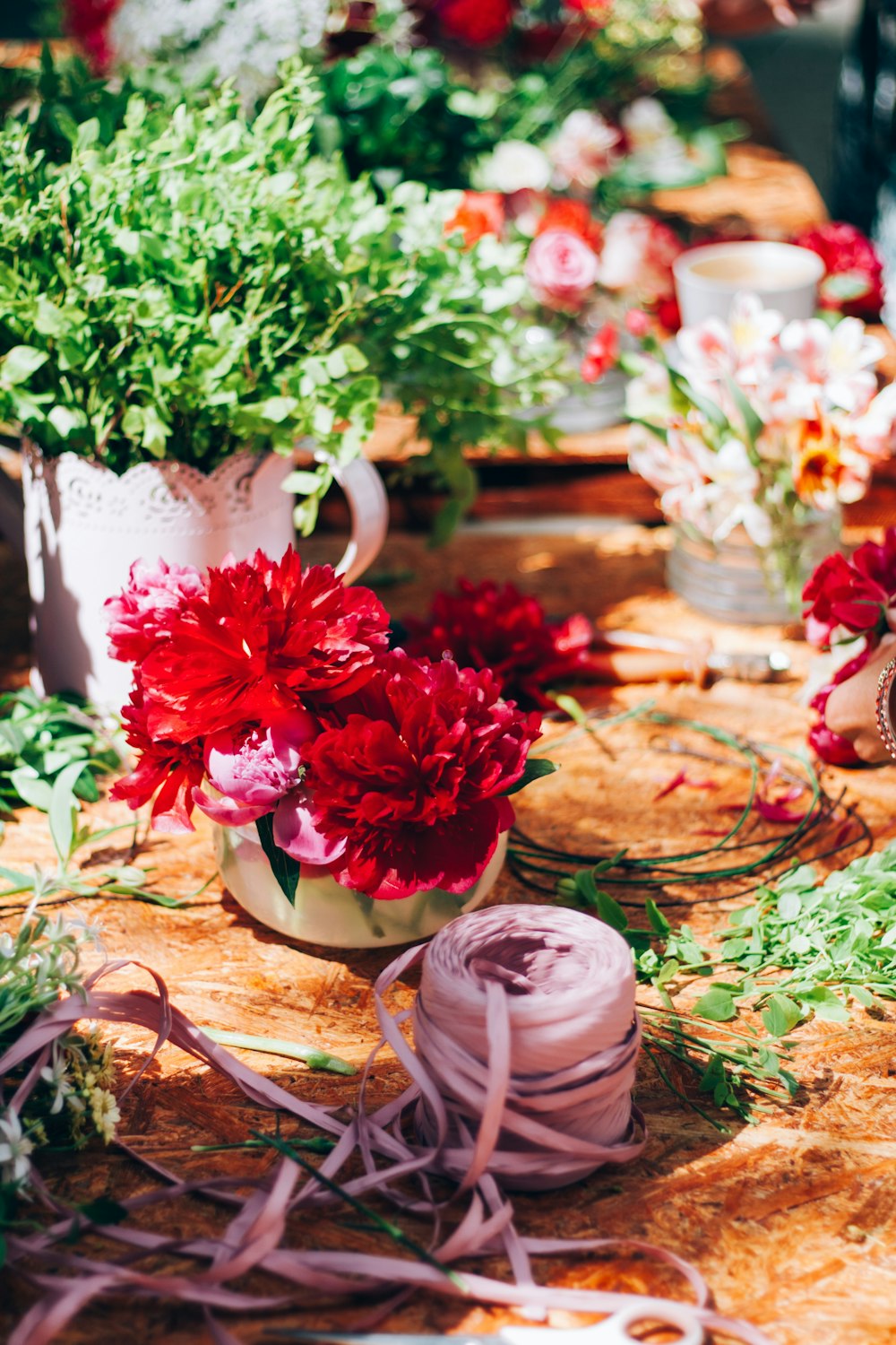 a table topped with lots of different types of flowers
