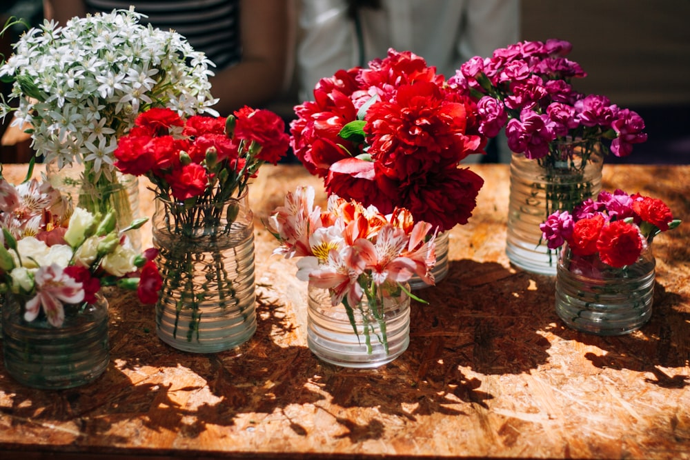 a table topped with vases filled with flowers