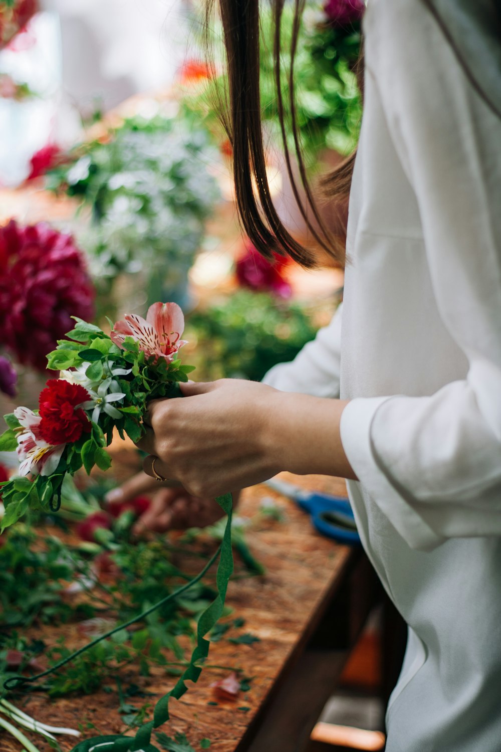 a woman arranging flowers in a flower shop