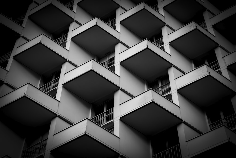 a black and white photo of a building with balconies