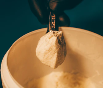 a person is holding a spoon with some food in it