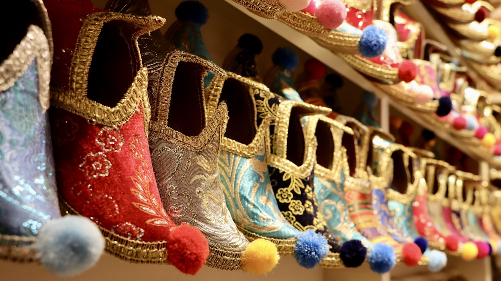 a row of colorful shoes hanging on a wall