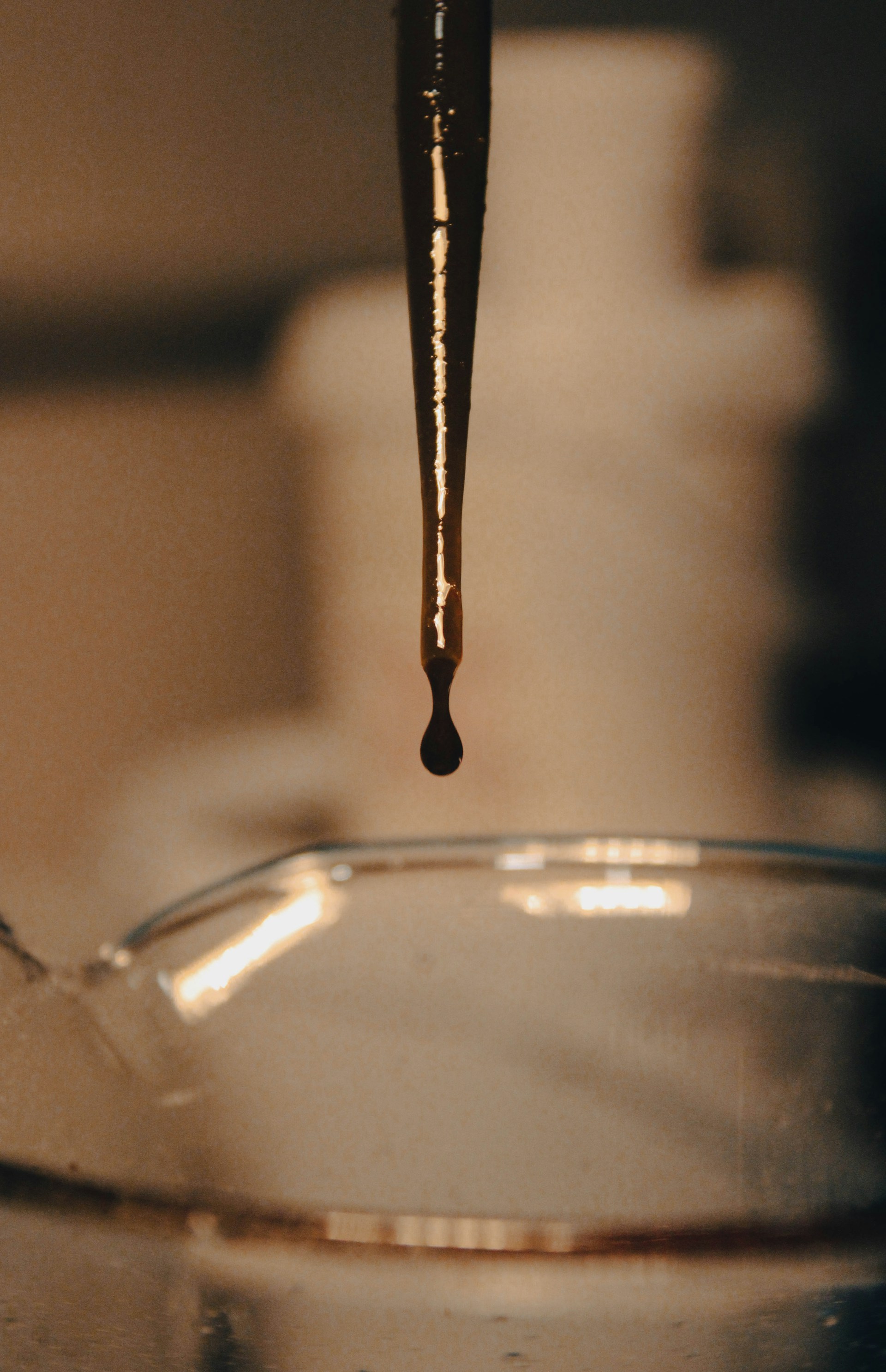 a drop of chocolate hangs from a spoon