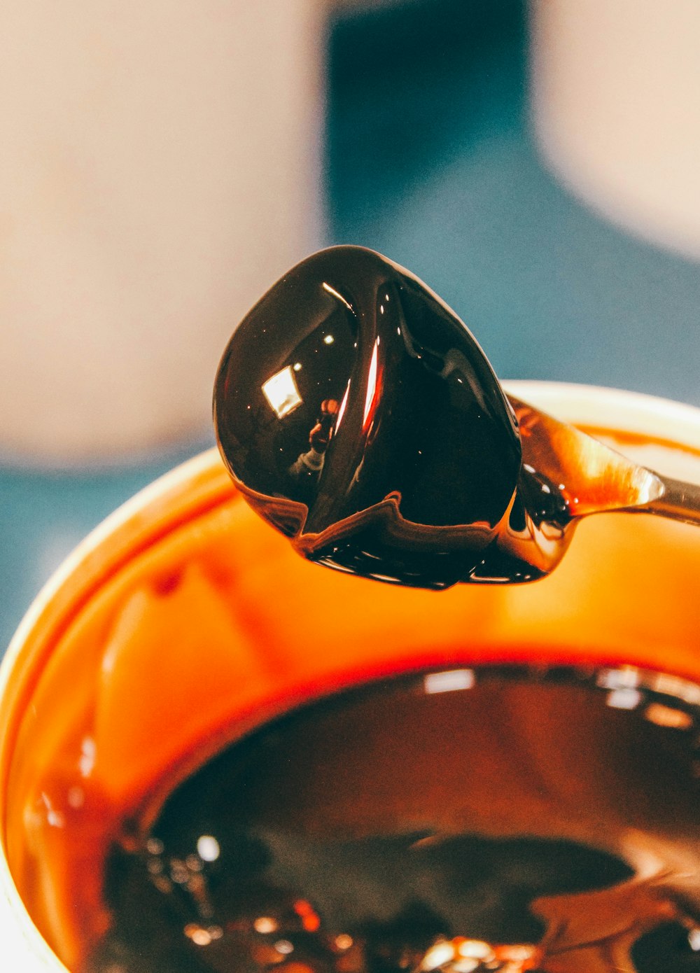 a spoon full of melted chocolate on top of a table