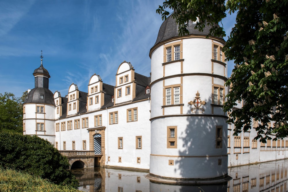 un grande castello bianco con un ponte di fronte