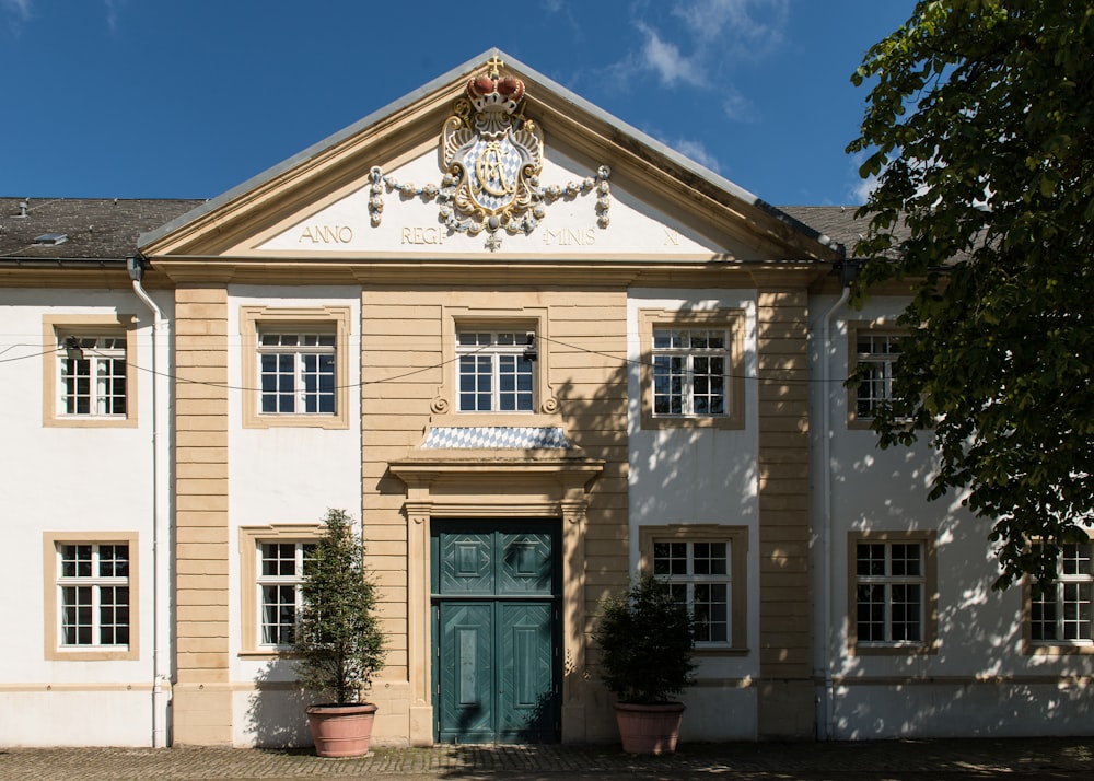 a large white building with a green door