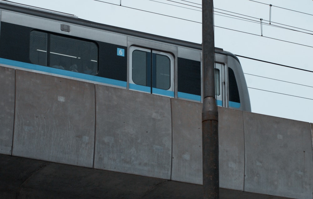 a train traveling over a bridge next to a tall building