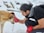 a man petting a dog in the snow