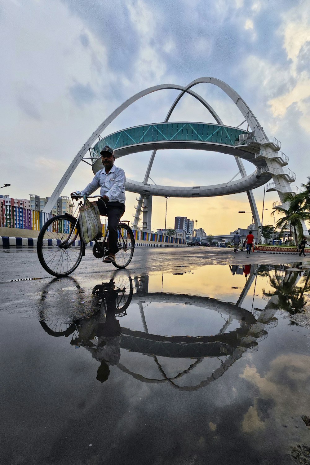 a man riding a bike across a puddle of water