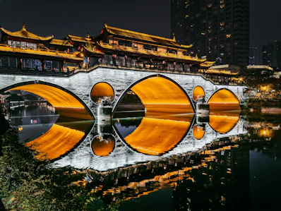 a bridge over a body of water with buildings in the background