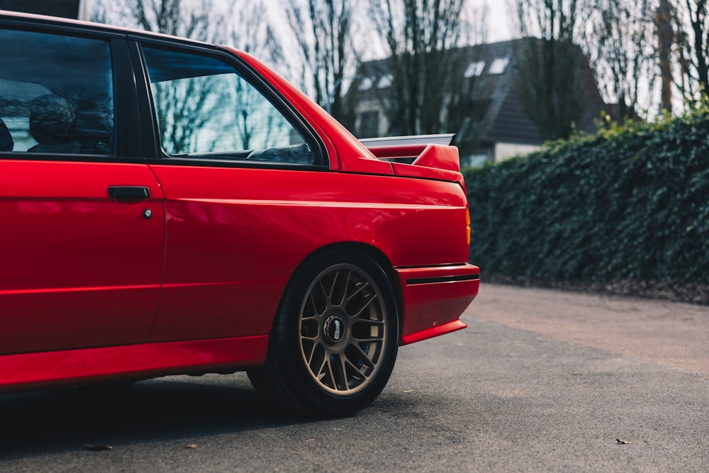 a red car parked on the side of a road