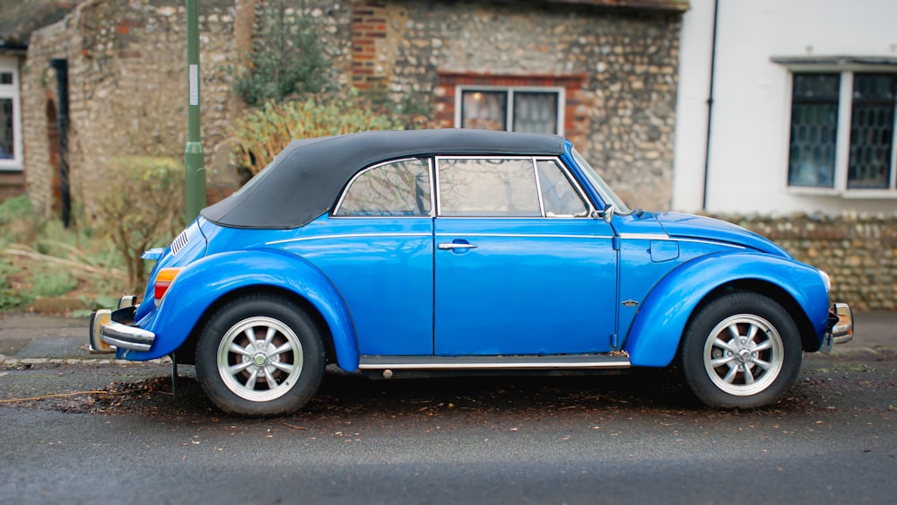 a blue car parked in front of a building