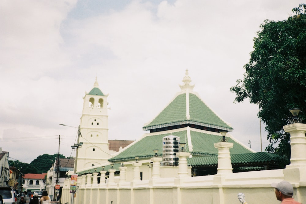 a large white building with a green roof