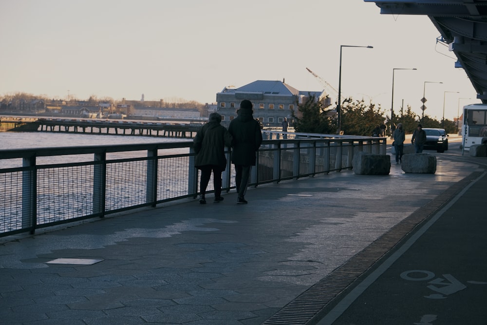 a couple of people that are standing on a bridge
