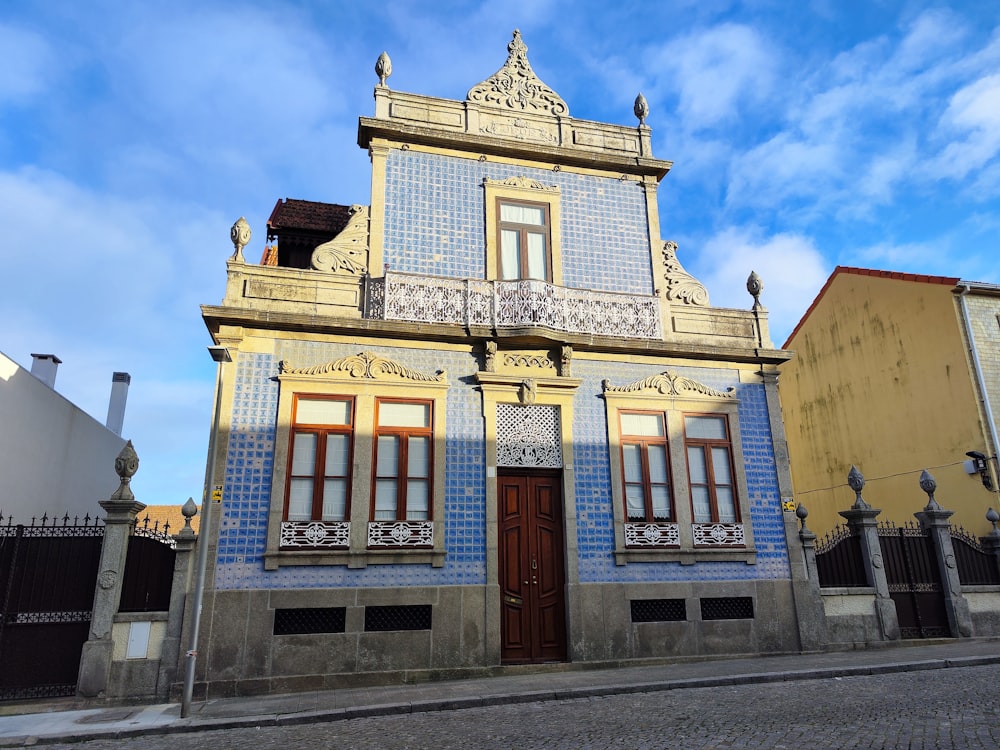 a blue and white building with a brown door