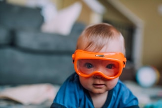 a small child wearing a pair of goggles