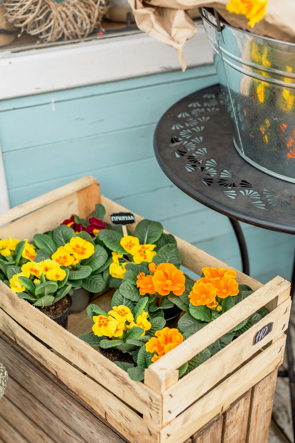 a wooden box filled with yellow and orange flowers