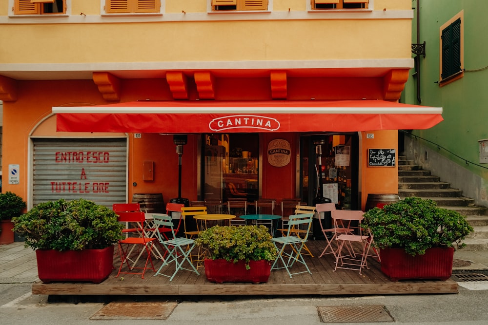 a restaurant with tables and chairs in front of it