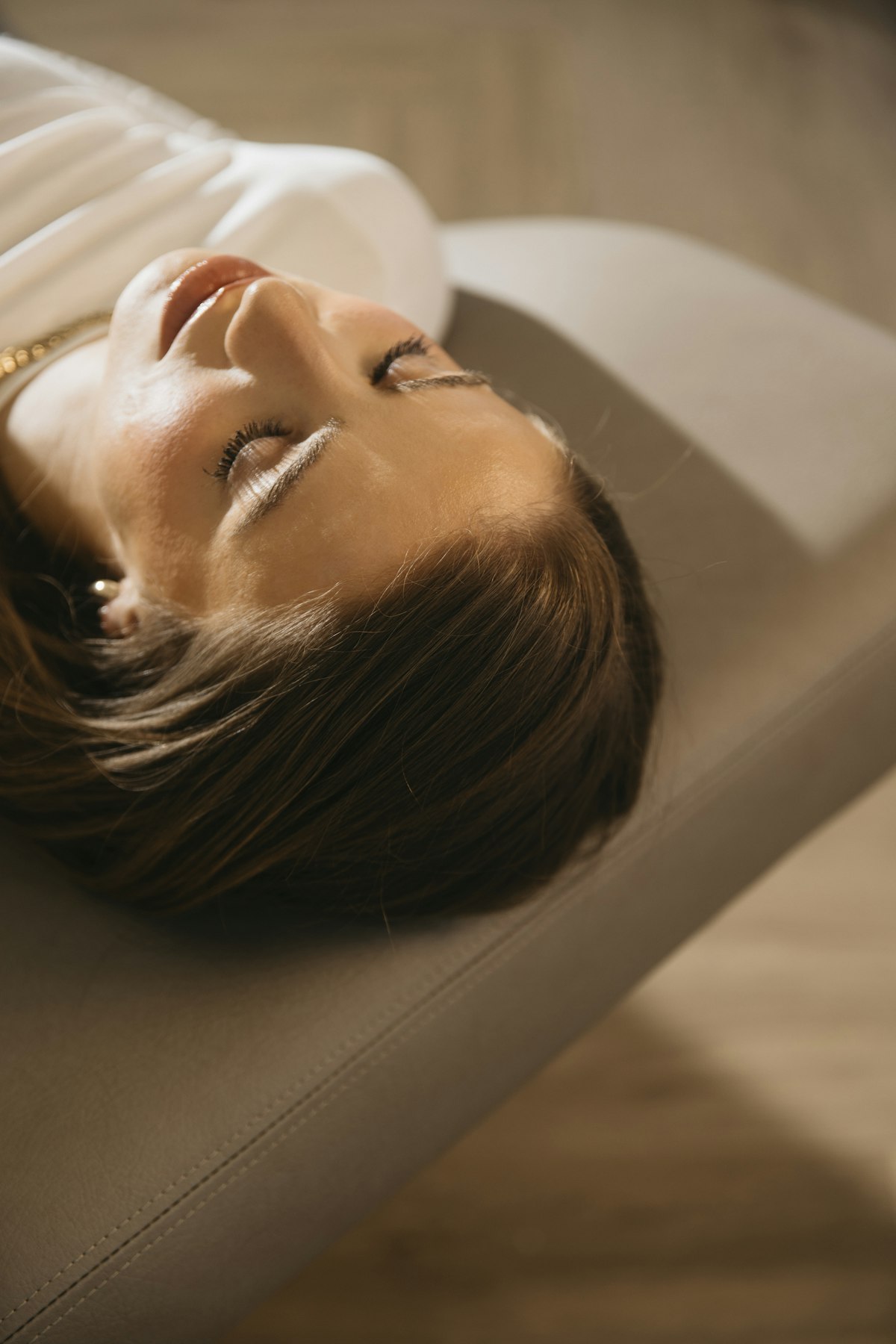 Woman resting peacefully during fertility acupressure treatment