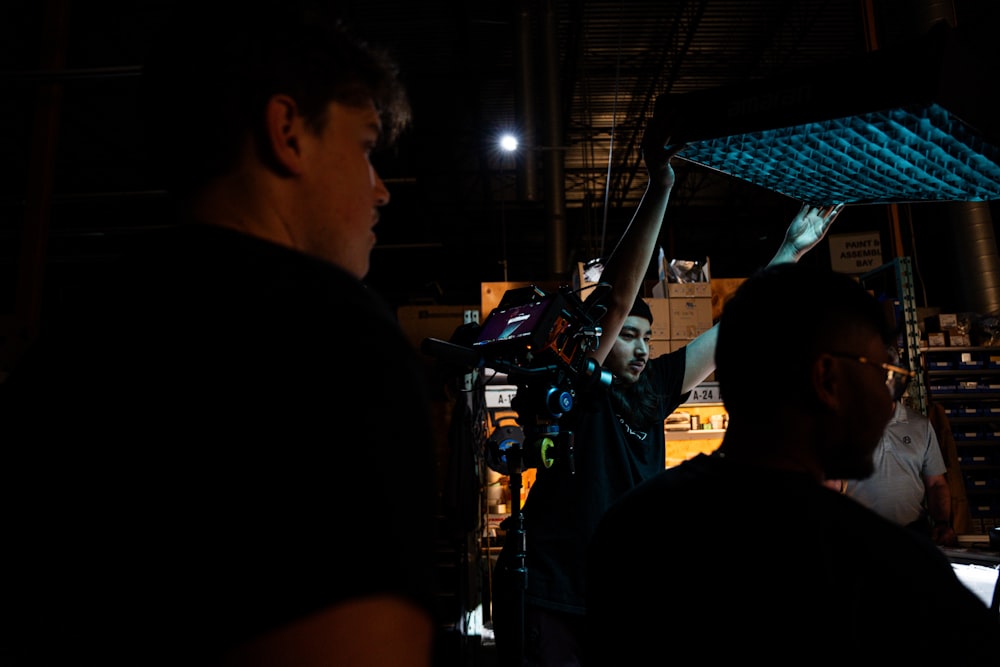 a group of people standing around a building in the dark