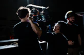 a man holding a camera up to another man