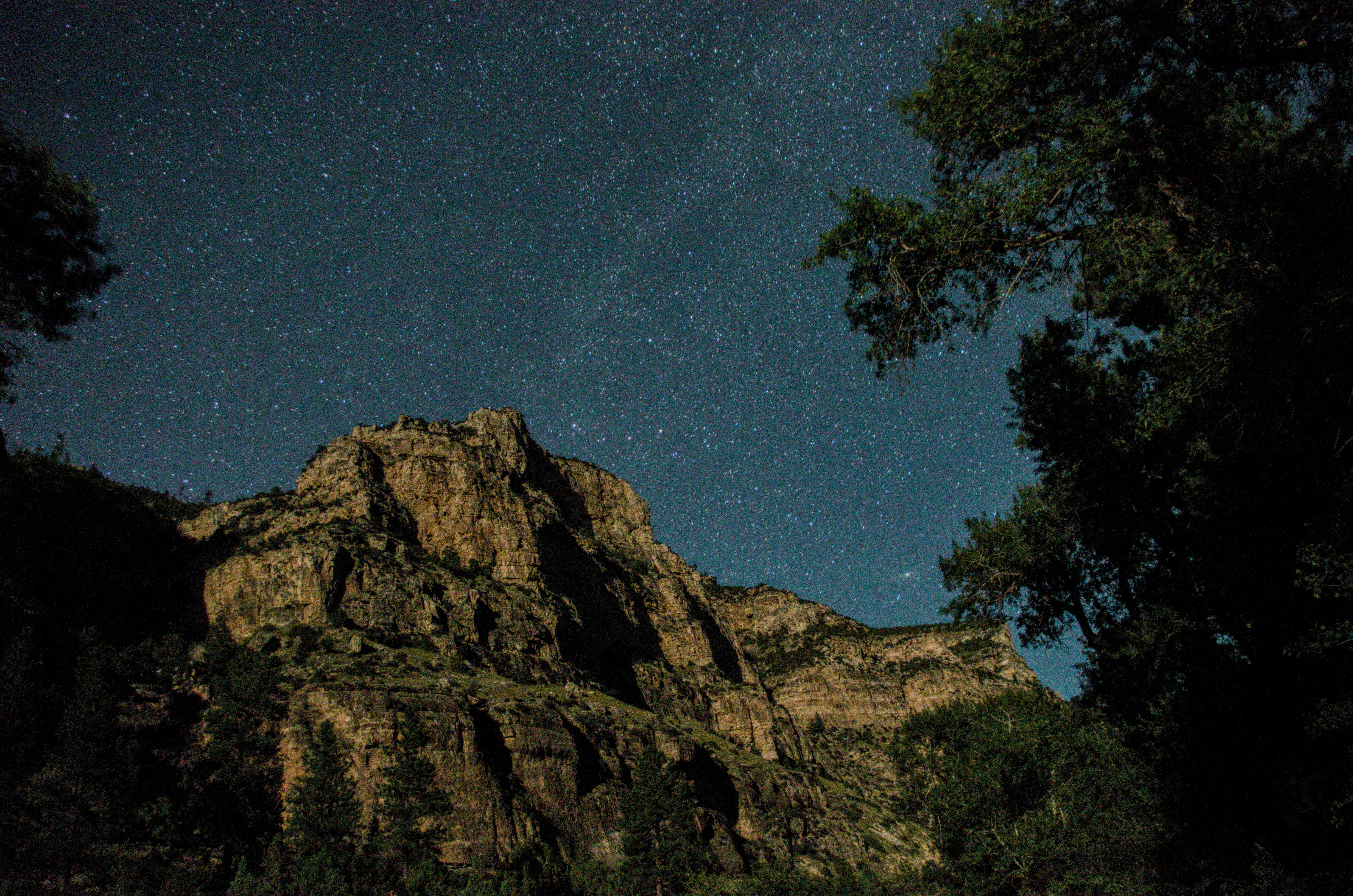 the night sky is full of stars above a mountain