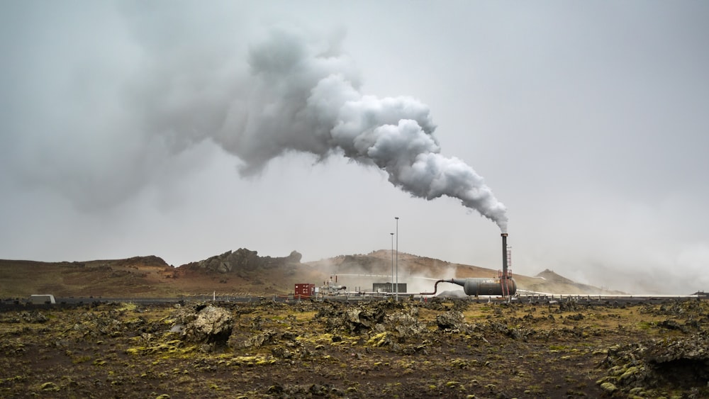 a large pipe emits smoke into the sky