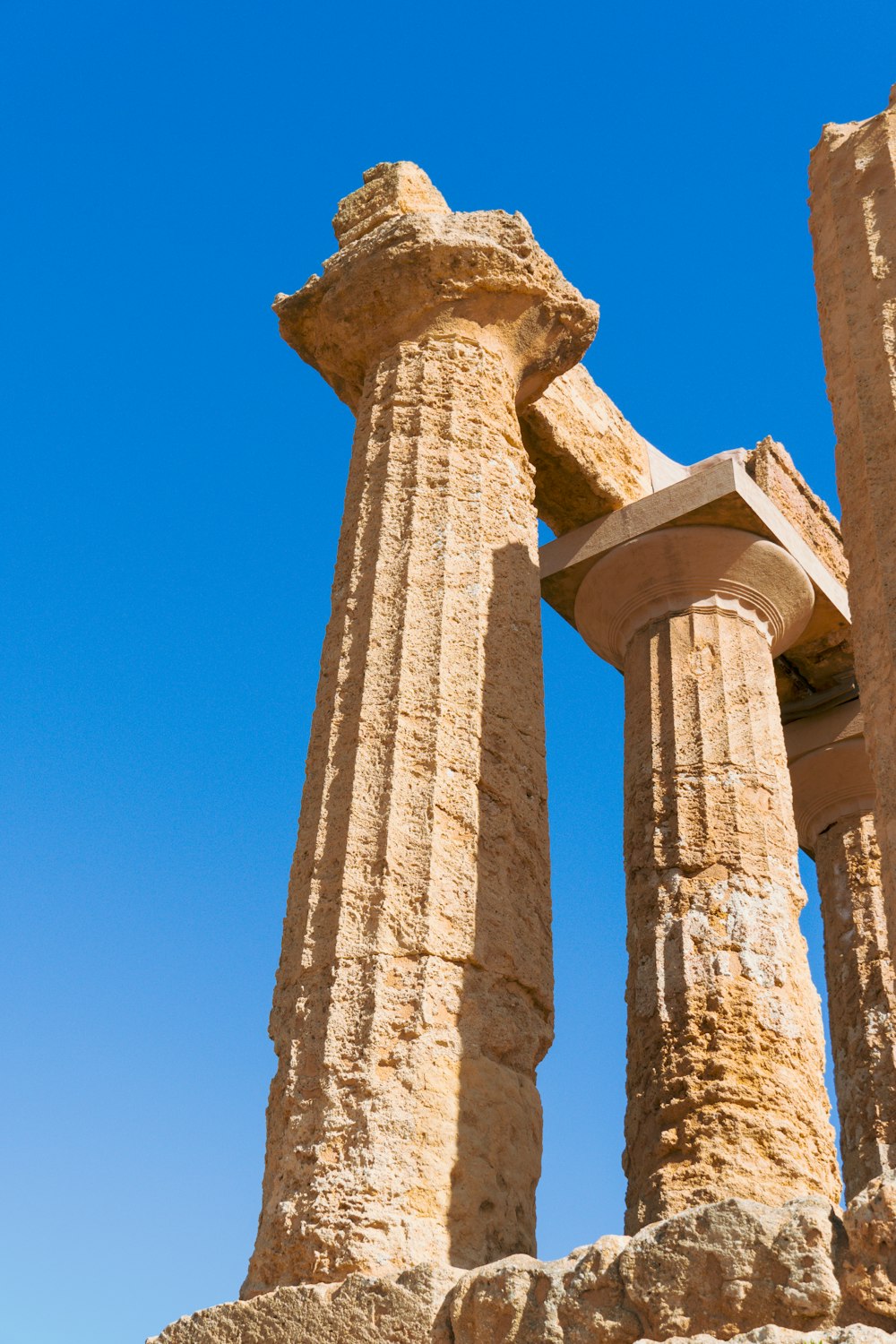 a couple of tall stone pillars sitting next to each other