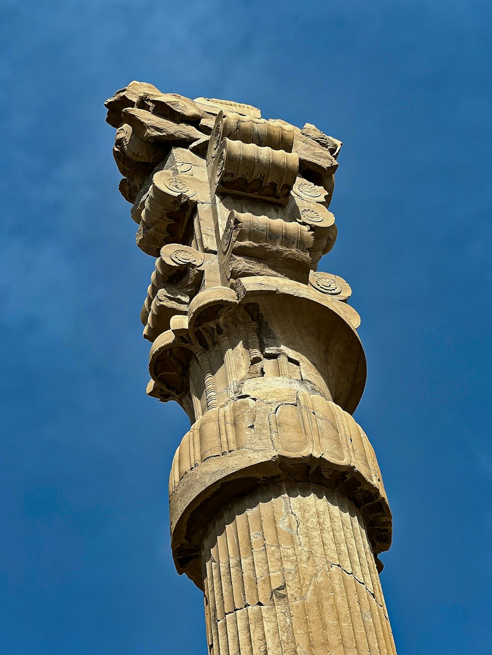 a tall stone column with a sky in the background